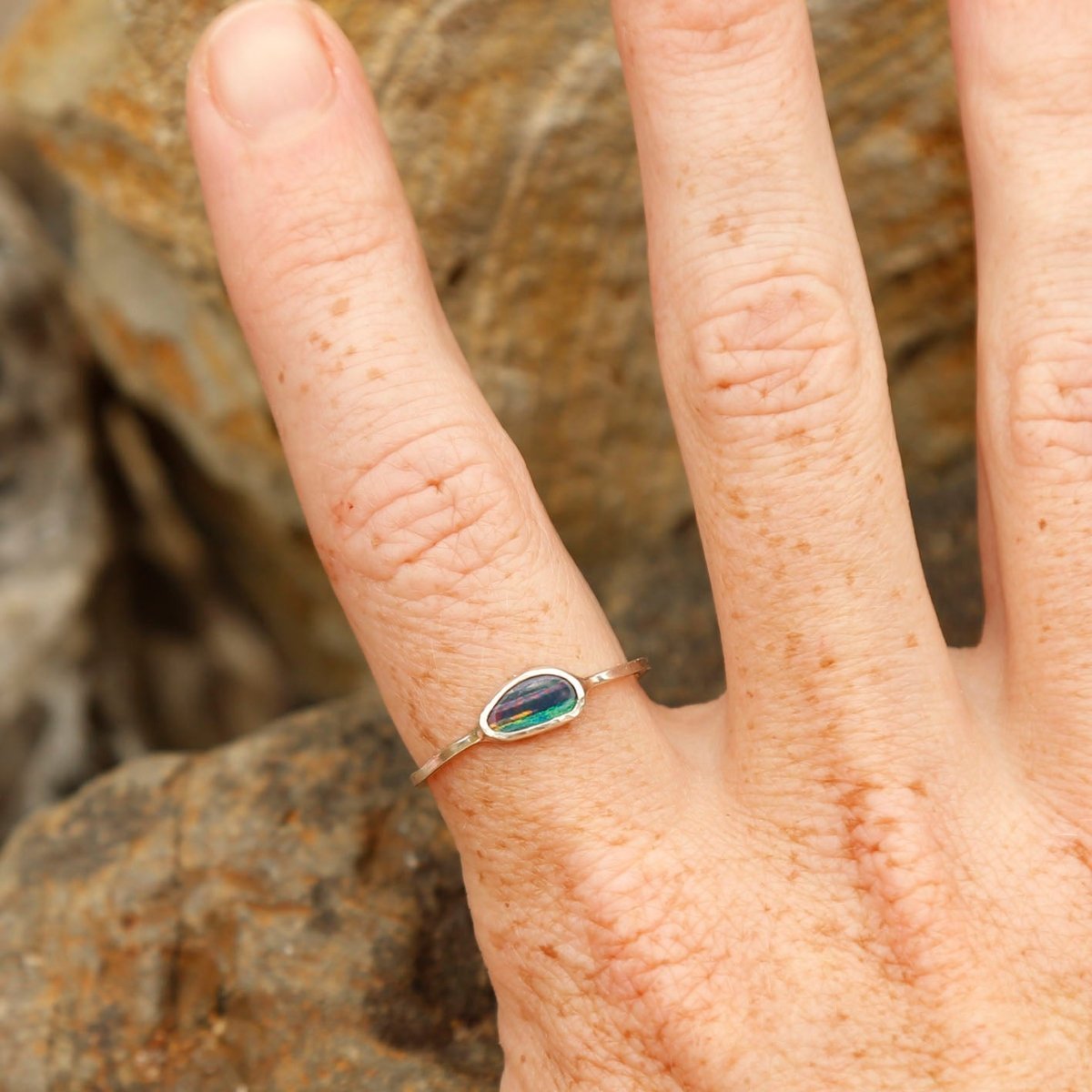 wearing an opal ring